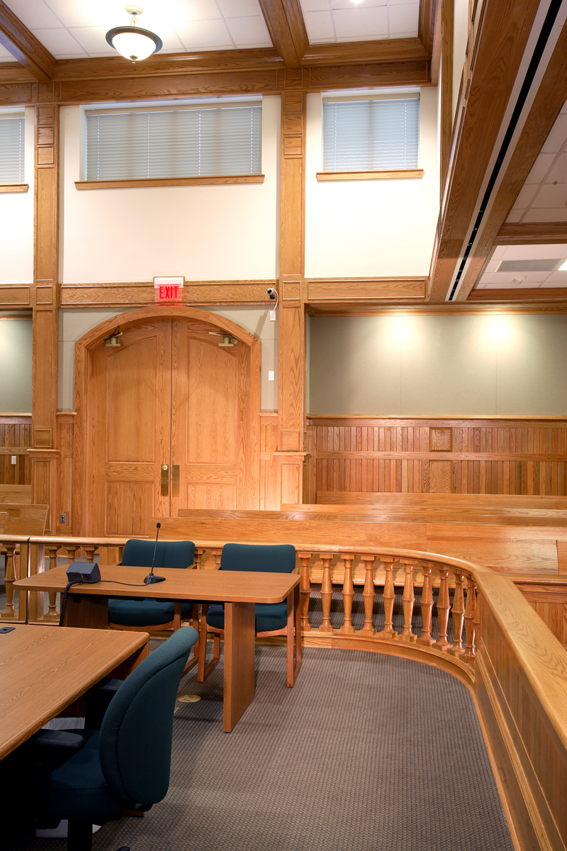 A hand placing a voting ballot into a ballot box during an election.